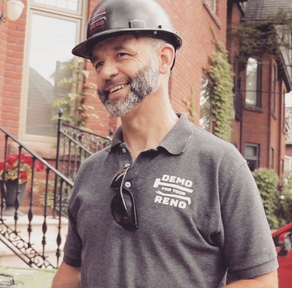 Patrick of Demo For Your Reno smiling in branded hard hat and polo on a Toronto street