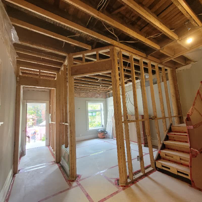 Selective demolition in a Toronto home, framing exposed and floor protection taped down